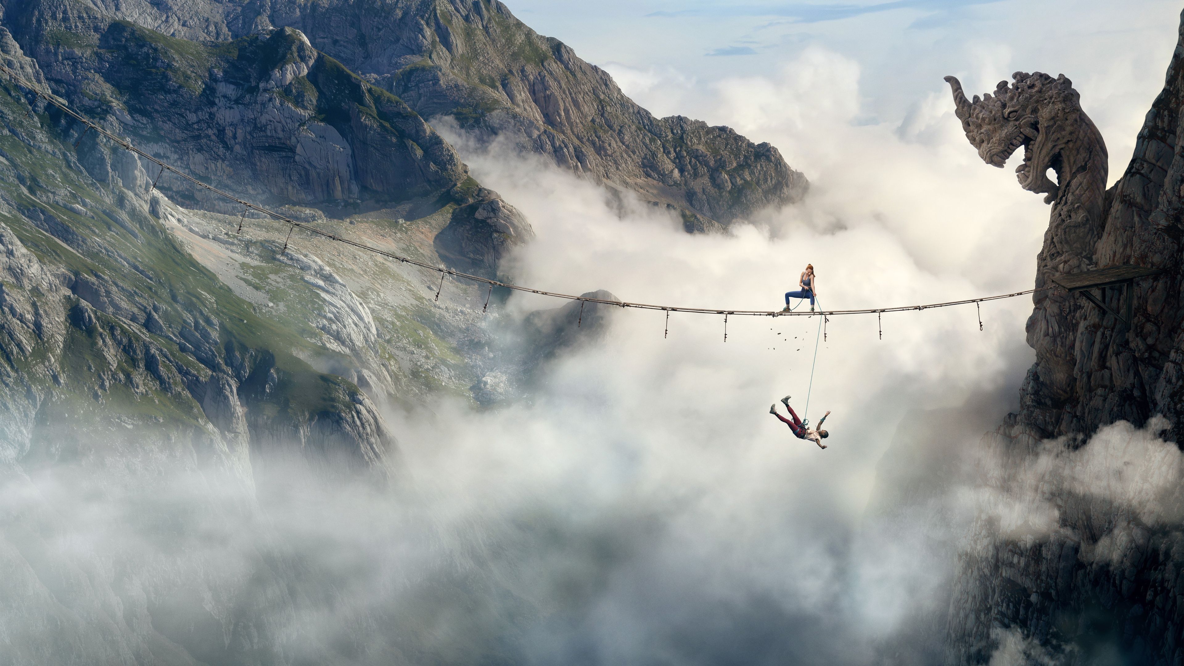 4K UHD Fall 2 Deadpoint mountain climbing wallpaper featuring a climber crossing a rope bridge above a misty mountain valley, high-resolution desktop background.