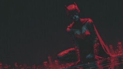 Crimson caped hero kneels surveying the rain slicked city