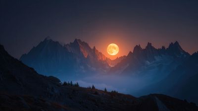 Vibrant Orange Moon Over Majestic Mountain Landscape