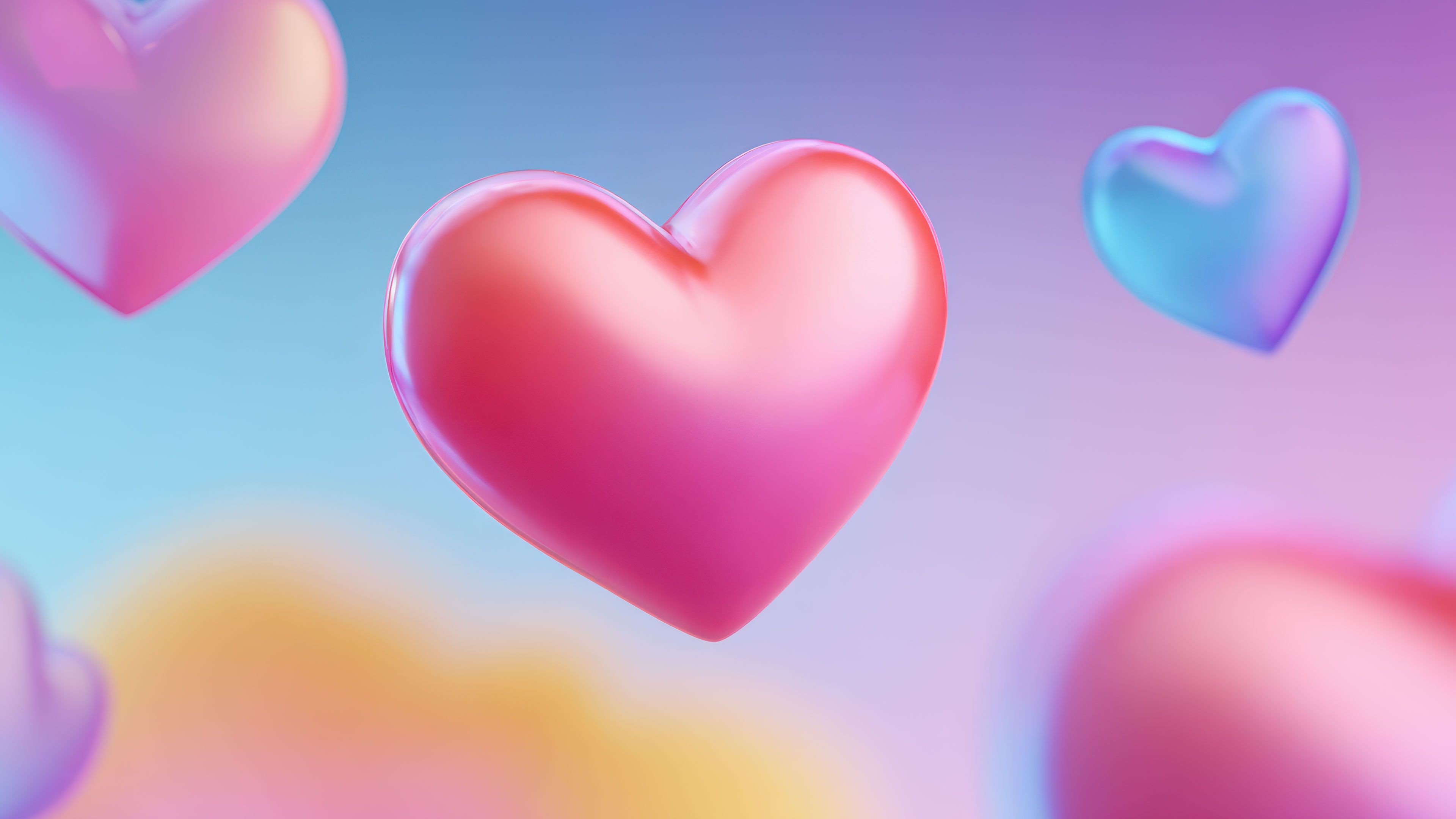 A dreamy wallpaper featuring soft, floating pastel hearts in pink and blue hues against a blurred, multi-colored background, creating a serene and whimsical atmosphere.