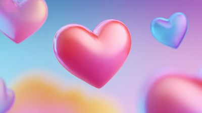 A dreamy wallpaper featuring soft, floating pastel hearts in pink and blue hues against a blurred, multi-colored background, creating a serene and whimsical atmosphere.