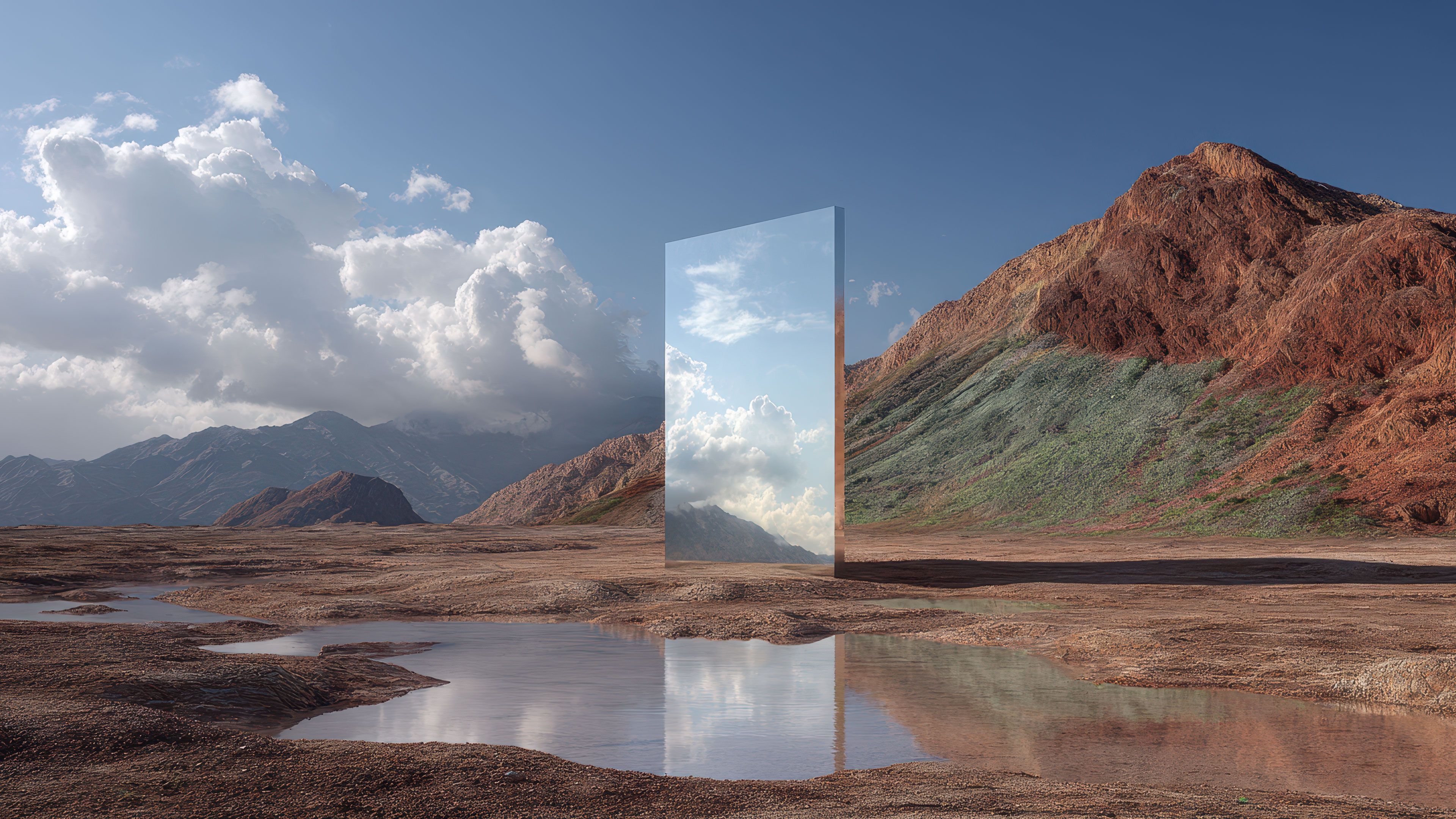 A large, vertical mirror stands in an arid mountainous landscape, reflecting a bright, cloud-filled sky, creating a surreal and serene contrast with the earthy surroundings.