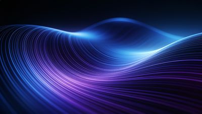 A dynamic abstract wallpaper featuring flowing waves of vibrant blue and purple hues, creating a sense of movement and depth against a dark background. The smooth, undulating lines evoke a calming and futuristic mood.