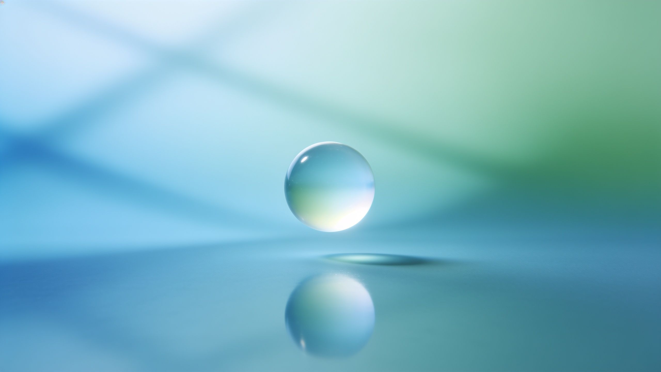 A single, translucent water droplet floats above a smooth surface, casting a soft reflection, set against a serene gradient background of blue and green hues, creating a tranquil and ethereal mood.