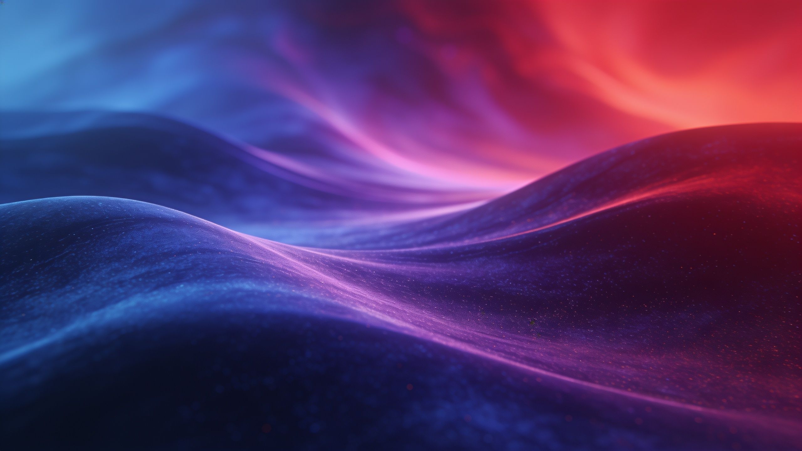 The wallpaper features dynamic, flowing abstract waves in vibrant shades of red and blue, creating a sense of movement and energy. The smooth gradients and interplay of colors evoke a serene yet lively mood.