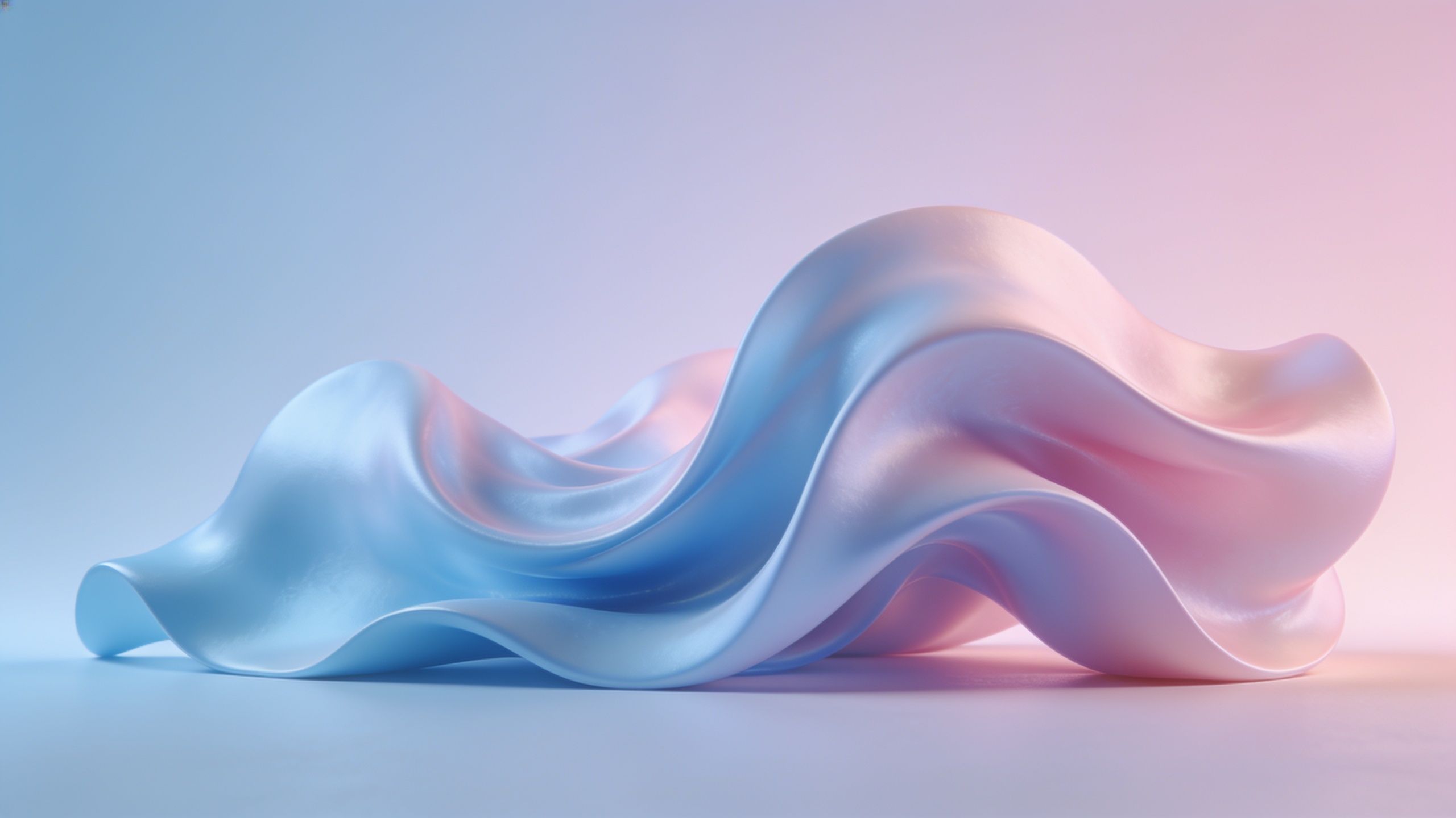 A smooth, flowing wave-like structure in soft pastel shades of blue and pink is illuminated by gentle, diffused light, creating a serene and calming atmosphere.