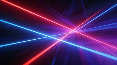 A dynamic display of vibrant neon laser beams in red, blue, and purple crisscrossing against a dark background, creating an energetic and futuristic atmosphere.
