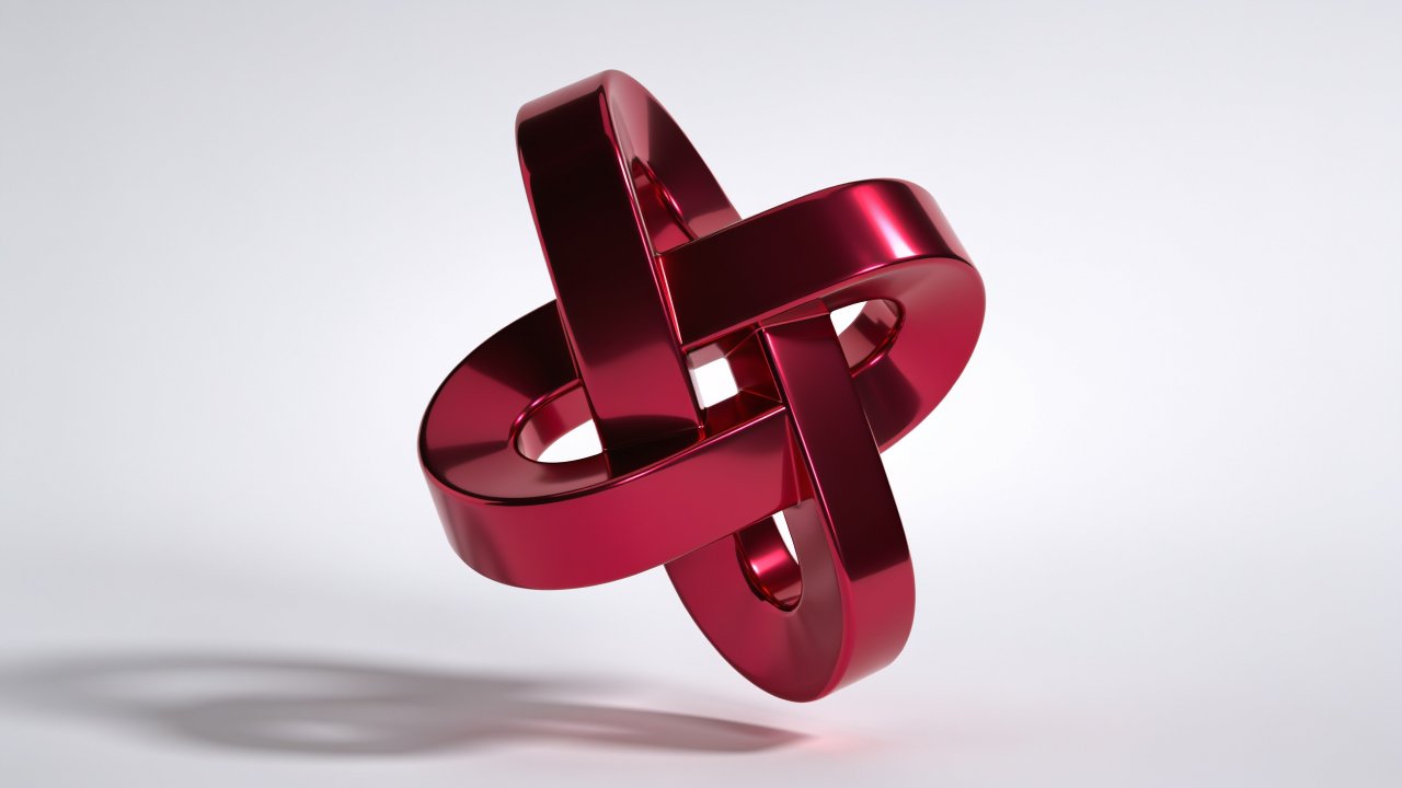 A sleek, red metallic abstract shape with intertwined loops is set against a plain white background, creating a modern and sophisticated mood. The shiny surface and intricate design evoke a sense of elegance and futuristic style.