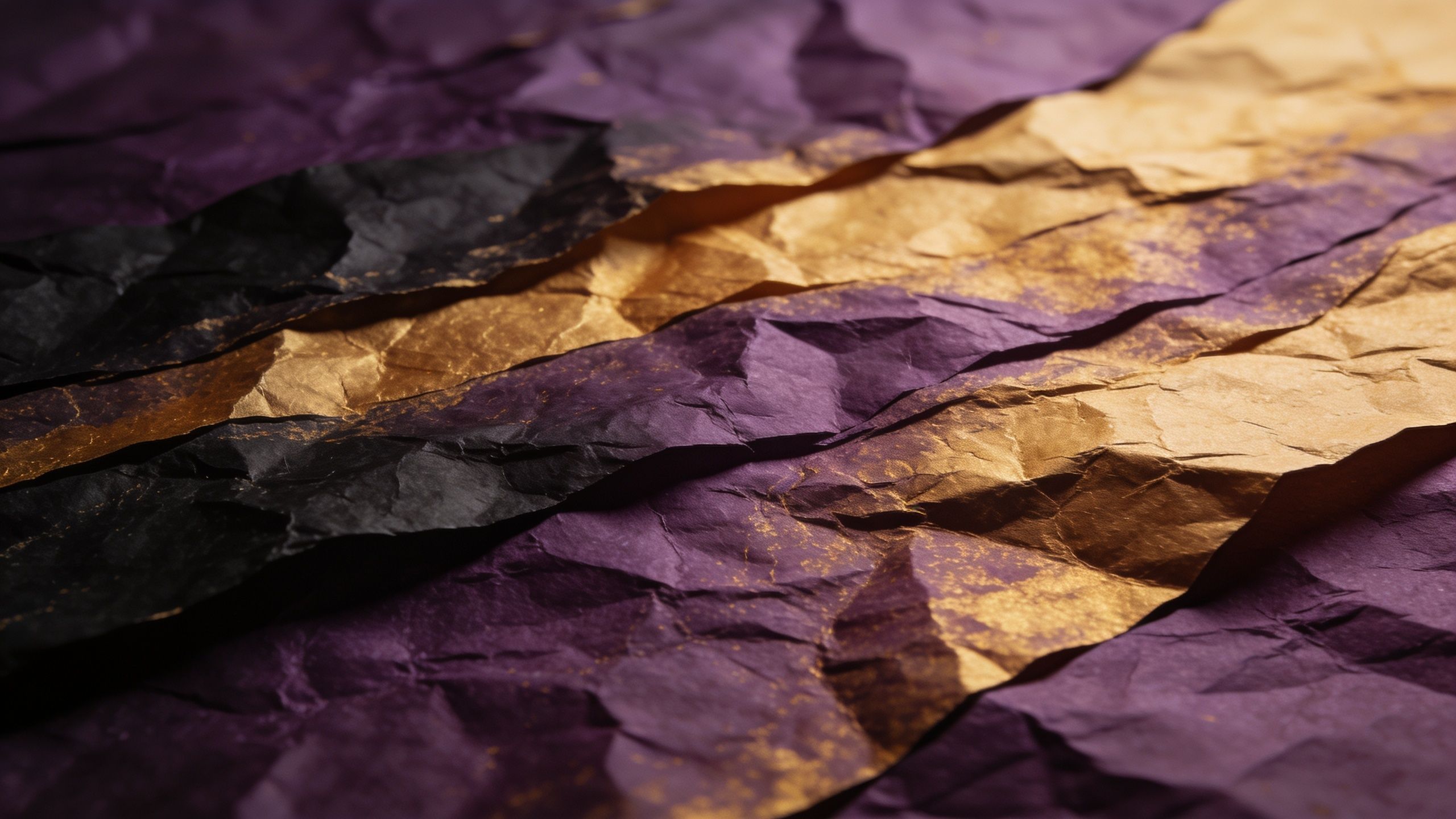 A close-up of crumpled paper art featuring rich purple and gold hues, creating a textured and luxurious appearance with a dynamic interplay of light and shadow.