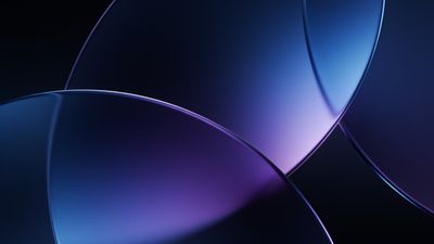 An abstract wallpaper featuring smooth, overlapping curves in shades of blue and purple, creating a serene and sophisticated atmosphere with a soft gradient effect.