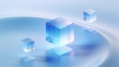 Translucent blue cubes float serenely in a soft-focus, light blue background, creating a tranquil and ethereal atmosphere.