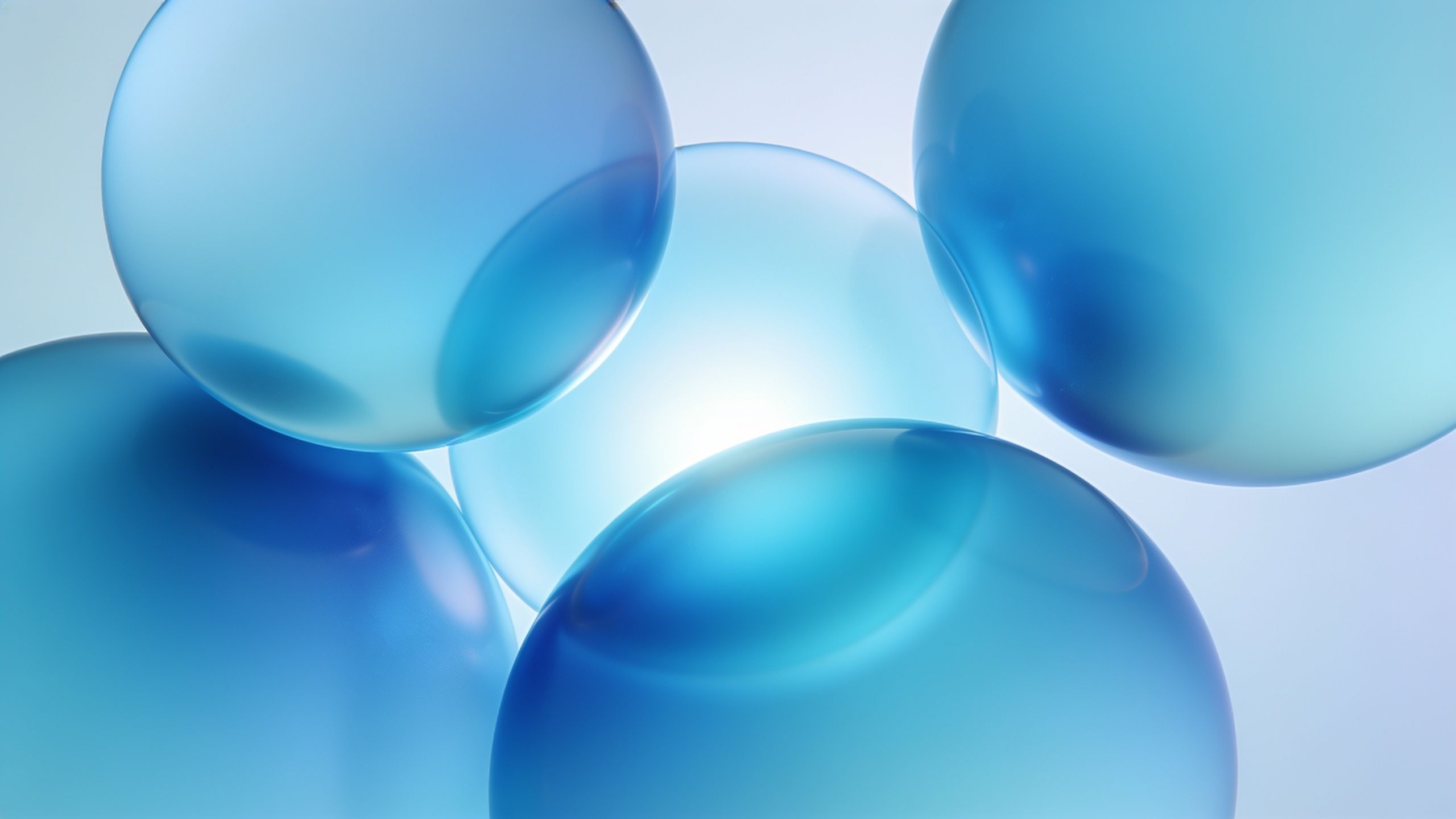 The image features several translucent blue spheres overlapping against a soft, light background, creating a calming and serene abstract composition. The gentle gradients and smooth textures evoke a sense of tranquility and depth.