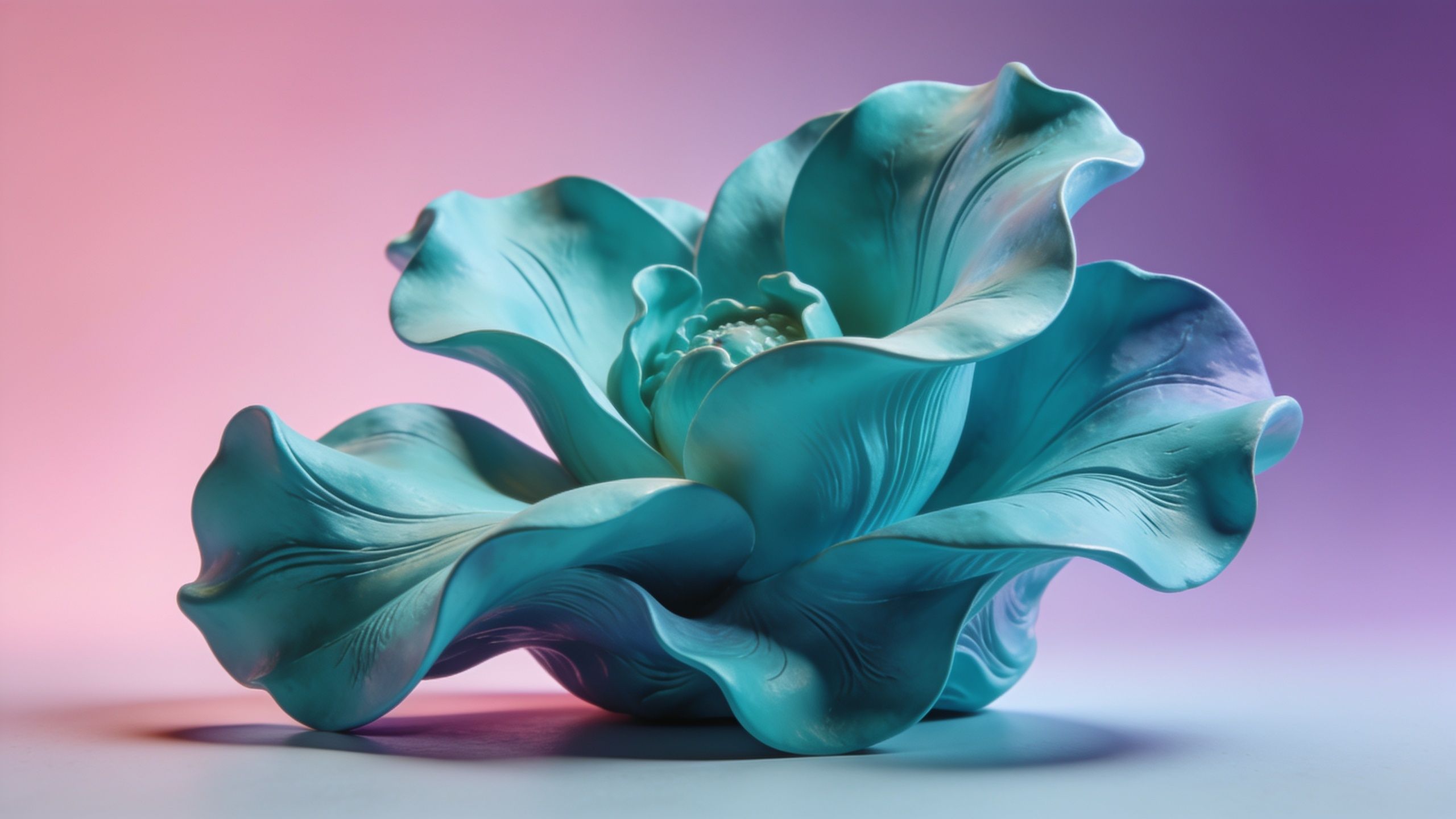 A delicate blue flower with intricately detailed petals is set against a soft gradient background transitioning from pink to purple, creating a serene and elegant atmosphere.
