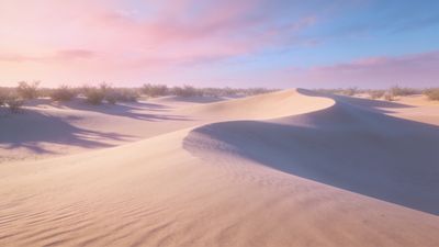 A tranquil desert landscape features gently rolling sand dunes under a soft, colorful sunset sky with hues of pink and blue, creating a serene and peaceful atmosphere. Sparse vegetation is visible in the distance, adding to the calmness of the scene.