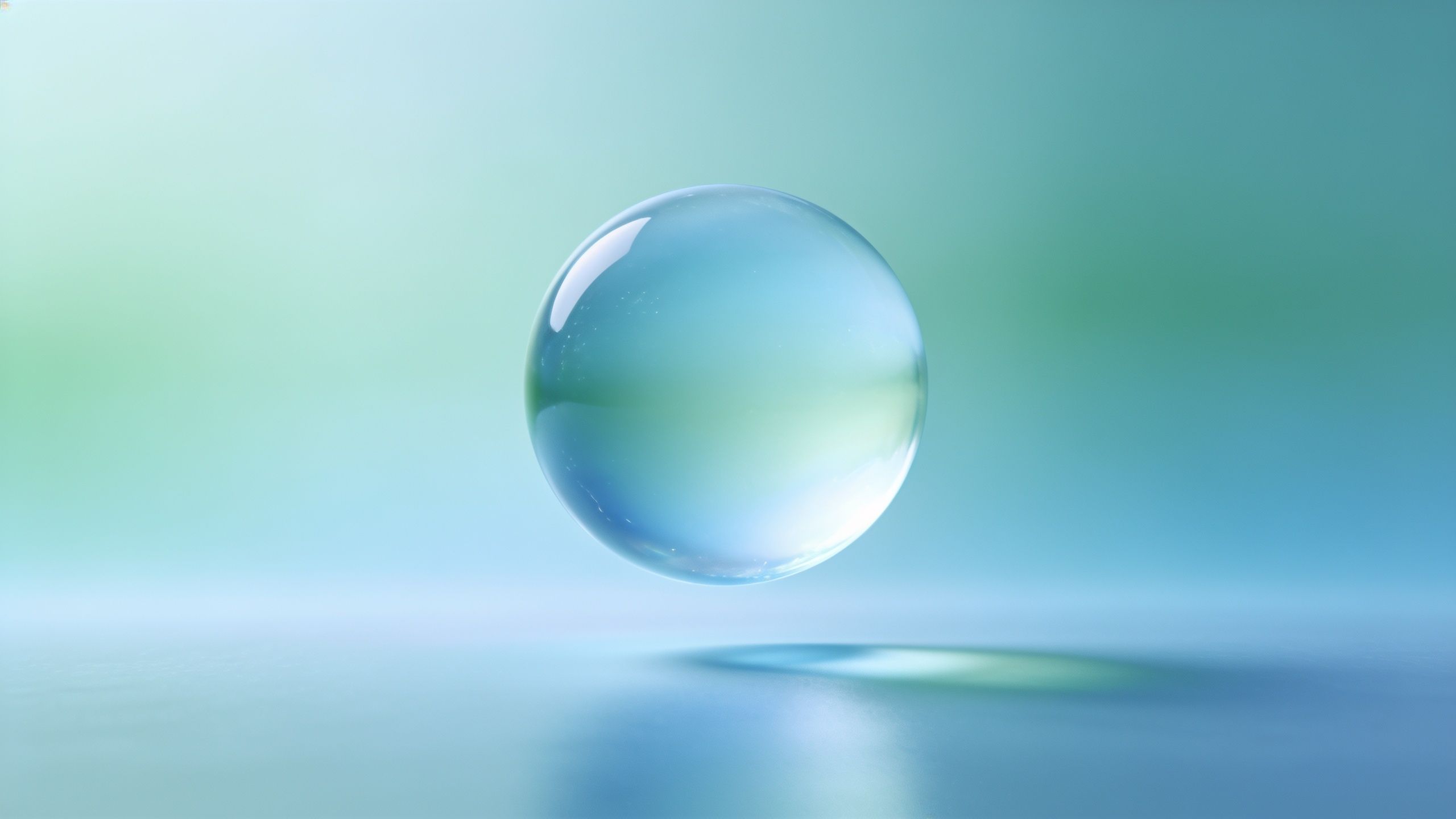 A translucent bubble floats gracefully against a soft gradient background of blues and greens, creating a tranquil and calming atmosphere.
