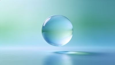 A translucent bubble floats gracefully against a soft gradient background of blues and greens, creating a tranquil and calming atmosphere.