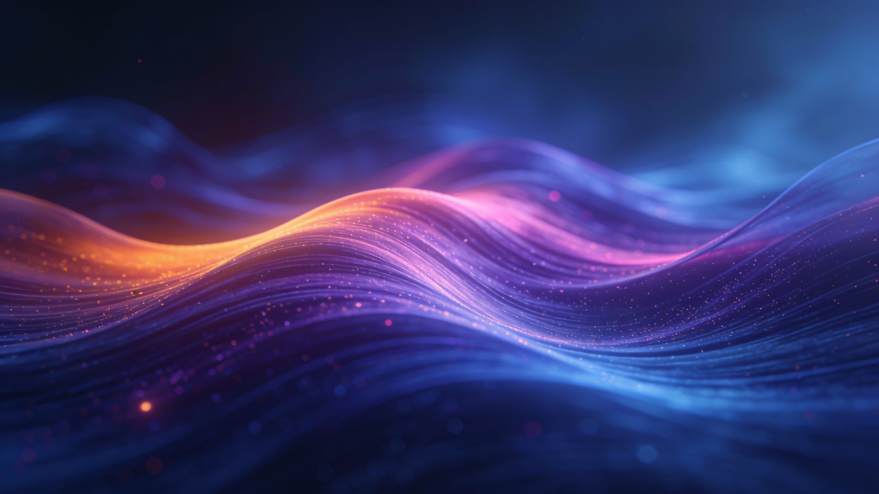 A dynamic and colorful abstract wallpaper featuring flowing waves of vibrant blue, purple, and orange hues, creating a sense of motion and energy against a dark background. The interplay of light and color evokes a lively and immersive mood.