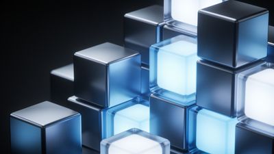 A cluster of metallic cubes, some glowing with a soft blue light, is arranged in a futuristic, abstract pattern against a dark background, creating a serene and high-tech atmosphere.