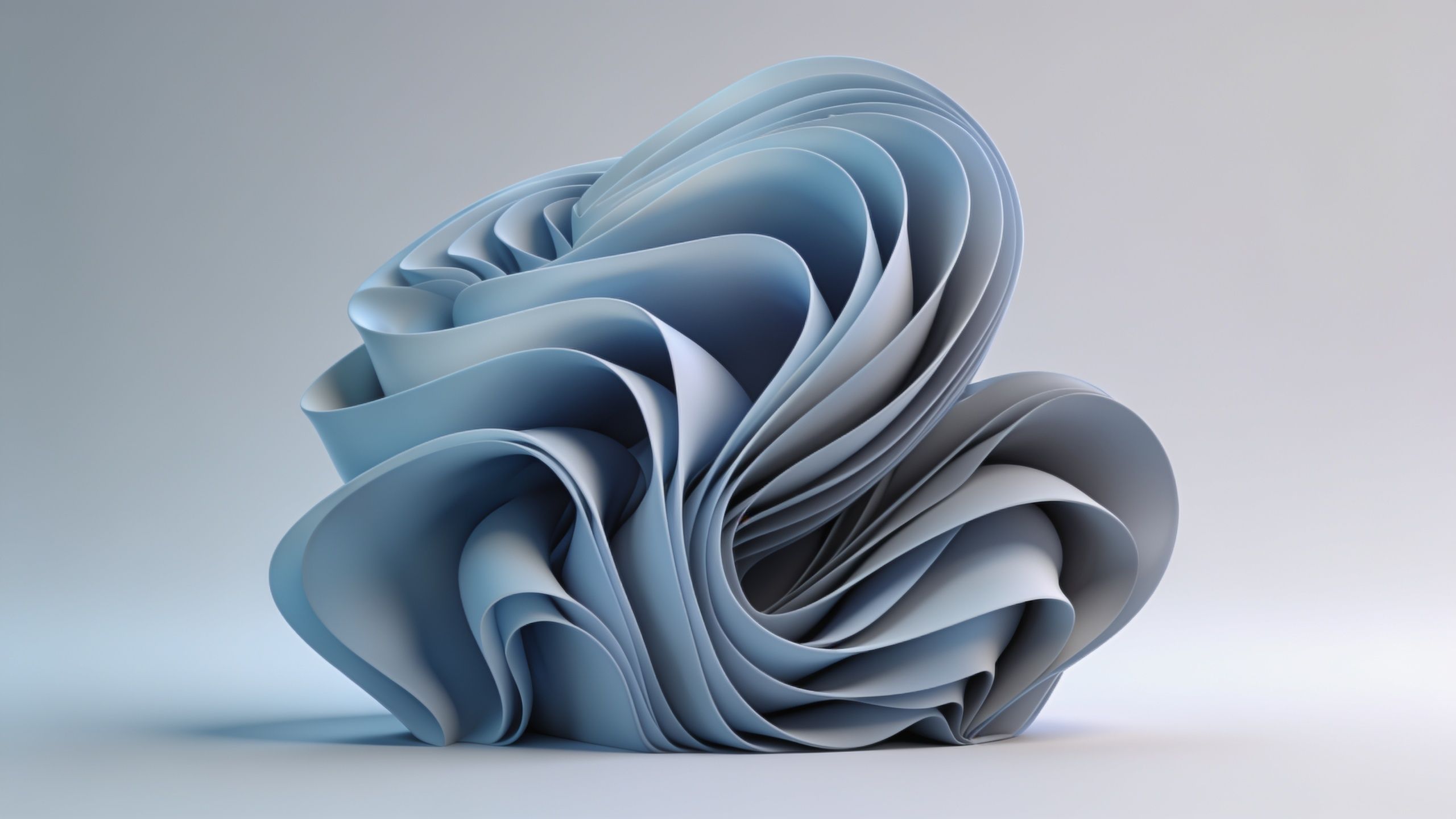 A complex and elegant abstract sculpture made of layered blue paper swirls gracefully against a soft, light background, creating a serene and sophisticated atmosphere.