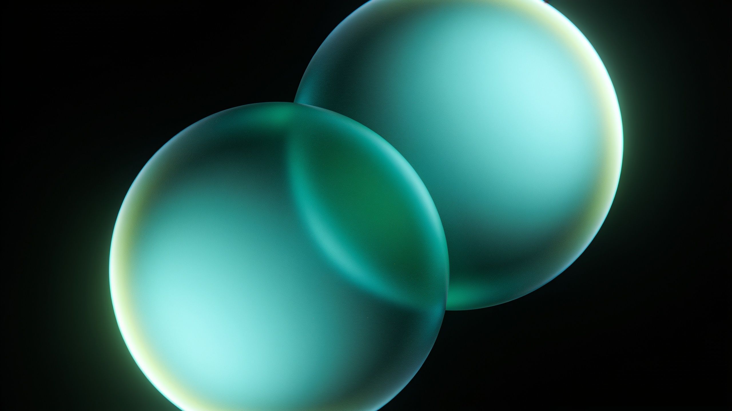 Two softly glowing turquoise spheres float against a dark background, creating a serene and futuristic ambiance.
