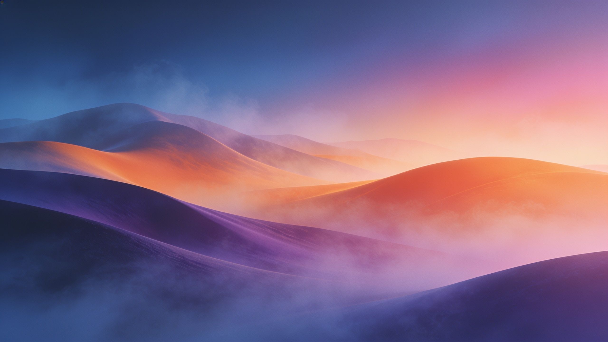 A serene sunset casts vibrant hues of orange, pink, and purple over misty, rolling hills, creating a tranquil and dreamy atmosphere. The soft blending of colors evokes a sense of calm and wonder.