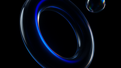 A glossy, glass-like torus ring edged with vivid blue neon light floats in a black void, accompanied by a small iridescent orb near its upper right edge. The stark contrast and subtle reflections create a sleek, futuristic mood.