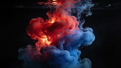 A vibrant underwater scene depicts a dynamic explosion of swirling red and blue ink, creating a mesmerizing and ethereal atmosphere against a dark background. The colors blend and contrast beautifully, evoking a sense of fluidity and artistic expression.