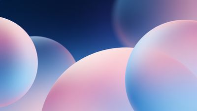 Soft pastel gradient spheres in shades of pink and blue float against a dark background, creating a serene and dreamy atmosphere.