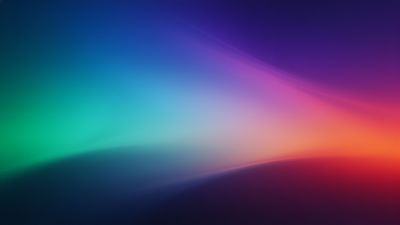 A vibrant gradient spectrum wallpaper featuring a smooth transition of colors from deep blue and green to warm orange and red, creating a dynamic and energetic mood. The abstract design evokes a sense of fluidity and movement.
