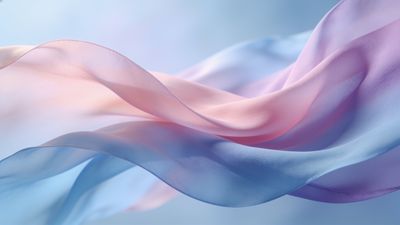 A soft, flowing fabric in pastel shades of pink, blue, and lavender gracefully drapes across the image, creating a serene and elegant atmosphere against a blurred, light background.