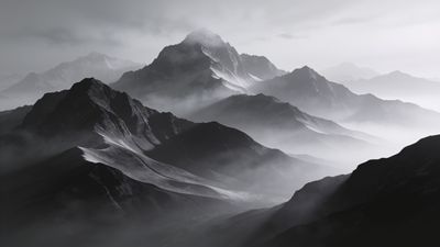 A dramatic black-and-white image of towering mountains shrouded in mist, creating a mysterious and serene atmosphere. The peaks are partially obscured by clouds, enhancing the sense of depth and majesty in the landscape.